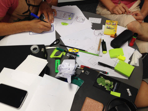 Developers creating paper prototypes during workshop