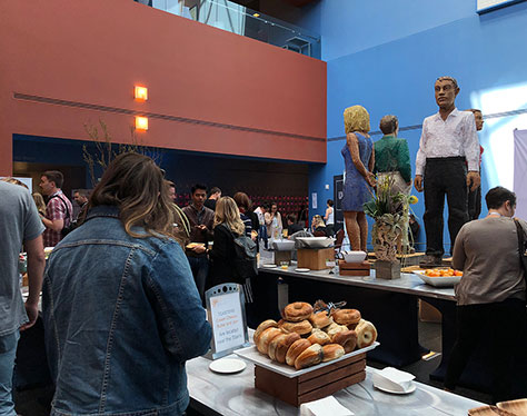 Attendees hanging around the buffet