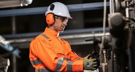 A worker wearing PPE to perform his job